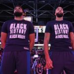 Minnesota Timberwolves center Karl-Anthony Towns (32), left, and center Rudy Gobert (27) stand during the singing of the national anthem before a game against the Portland Trail Blazers at Moda Center.