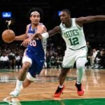 Philadelphia 76ers guard Jared McCain (20) drives to the basket against Boston Celtics guard Lonnie Walker IV (12)